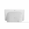 The back of a white Google Nest Hub smart display with a gray fabric speaker base, shown on a white background with a power cord attached. Produktbild-Vorschau