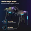 A gaming desk with RGB lighting, shown with weights on top to demonstrate its stability and load capacity. Voir les images du produit