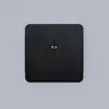A black square device with gold connectors in the center, set against a plain light gray background. Anteprima dell’immagine prodotto