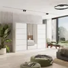 A modern bedroom with a large white wardrobe with mirrored doors, a green armchair, and a large window overlooking a garden. Produktbild-Vorschau