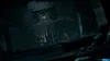 A dark, atmospheric scene with a hanging saw and a single light bulb. Produktbild-Vorschau