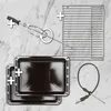 A collage of oven accessories including a rotisserie spit, baking trays, a wire rack, and a meat thermometer, arranged on a marble-like background. Produktbild-Vorschau