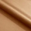 A close-up view of a folded piece of brown fabric. Produktbild-Vorschau