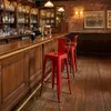A bar interior with wooden paneling, shelves stocked with bottles, and red bar stools. Podgląd zdjęcia produktu
