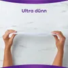 Two hands are holding up a very thin white product against a marble background. Produktbild-Vorschau