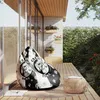 A bean bag chair with a gaming theme is placed on a wooden deck next to a small round table. Voir les images du produit