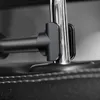 A close-up view of a black car mount attached to a silver metal rod, resting on a black leather car seat. Voir les images du produit