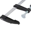 A close-up view of a metal and black F-clamp, also known as a bar clamp or pipe clamp, used for woodworking. Náhled obrázku produktu