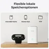 A black security camera and a white hub device are displayed on a wooden surface, with icons and text above indicating storage options. Produktbild-Vorschau