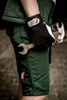 A person wearing work clothes and gloves holds two wrenches. Produktbild-Vorschau
