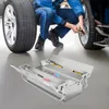 A mechanic is working on a car tire, with a toolbox in the foreground. Podgląd zdjęcia produktu