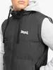 Close-up shot of a person wearing a black puffer vest over a grey hoodie. Anteprima dell’immagine prodotto