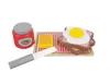 A toy breakfast set with a jar of jam, a cutting board with toast, a fried egg, butter, and a knife. Anteprima dell’immagine prodotto