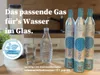 A kitchen counter with CO2 cylinders, a glass of water, and a water bottle. Produktbild-Vorschau