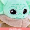 Close-up of a plush toy's face, with a pink banner at the bottom containing text. Produktbild-Vorschau
