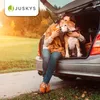 A woman and her dog are sitting in the open trunk of a car, enjoying the outdoors. Náhľad obrázku produktu