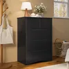 A black dresser with drawers is shown in a room setting, next to a coat rack with a bag and a window. Podgląd zdjęcia produktu