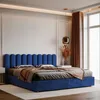 A bedroom scene with a blue upholstered bed. Anteprima dell’immagine prodotto