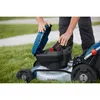 A person is inserting a battery into a Bosch lawnmower. Voir les images du produit