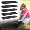 A young girl is shown in a garden setting, interacting with black metal garden edging. Produktbild-Vorschau