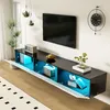 A modern living room with a wall-mounted TV and a sleek black and white TV stand with blue LED lighting. Produktbild-Vorschau