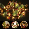 A collage of Christmas decorations including a string of lights with pinecones and berries, a small Christmas tree, and a Christmas wreath. Produktbild-Vorschau
