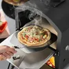A pizza is being removed from an outdoor pizza oven using a pizza peel. Produktbild-Vorschau