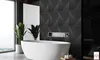 A modern bathroom with a freestanding bathtub and a textured black wall. Produktbild-Vorschau