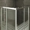 A close-up view of a modern shower cabin corner with frosted glass panels and metallic framing, set against a dark tiled wall. Produktbild-Vorschau