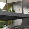 An outdoor dining area with a table and chairs under a canopy, surrounded by plants and modern lighting. Produktbild-Vorschau