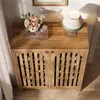 A wooden cabinet with slatted doors, decorated with a bouquet of flowers and a lamp on top. Anteprima dell’immagine prodotto