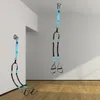 Two sets of suspension training straps are shown hanging from the ceiling and a wall mount in a room with wooden floors and white walls. Anteprima dell’immagine prodotto