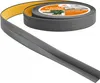 A roll of gray flexible baseboard trim with yellow adhesive backing is shown, partially unrolled. Náhled obrázku produktu