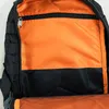 Close-up view of the interior of a black backpack with an orange lining. Produktbild-Vorschau