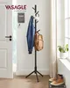 A hallway scene showing a black coat rack with a jacket, backpack, and headphones on it, near a door and a window with curtains. Náhled obrázku produktu