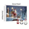 A Christmas advent calendar with numbered doors and a winter scene featuring Santa Claus, a lighthouse, and a deer. Three gnome figures are in the foreground. Produktbild-Vorschau