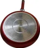 The bottom of a red frying pan is shown against a white background. Anteprima dell’immagine prodotto