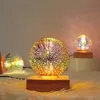 A decorative LED lamp with a crystal ball emitting colorful light, placed on a wooden base. Produktbild-Vorschau