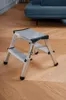 A two-step aluminum stepladder is shown on a wooden floor. Produktbild-Vorschau