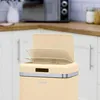 A close-up of a cream-colored retro-style trash can with its lid open, set against a kitchen background. Náhled obrázku produktu