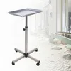 A silver rolling trolley with a tray on top, set against a blurred background of a salon or spa. Náhled obrázku produktu