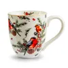 A white ceramic mug with a Christmas-themed design featuring birds and pine branches. Voir les images du produit