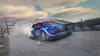 A blue rally car driving on a snowy road. Produktbild-Vorschau