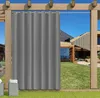 An outdoor curtain hanging on a pergola, with a modern house and garden in the background. Náhled obrázku produktu