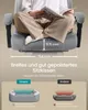 A person sitting in a gaming chair, with dimensions and feature comparisons shown. Produktbild-Vorschau