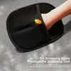 A hand wearing a black pet grooming glove on a gray surface with some white fur. Produktbild-Vorschau