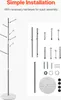 A coat rack and its assembly parts are shown against a light gray and white background. The coat rack is assembled on the left, and the parts are laid out on the right. Náhled obrázku produktu