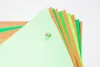 A fan of green and brown paper or cardstock is held together by a small, light-colored pin. Náhľad obrázku produktu