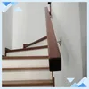 A wooden handrail attached to a white wall next to a wooden staircase. Náhľad obrázku produktu