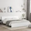 A white bed frame with a headboard is shown in a bedroom setting. Náhled obrázku produktu